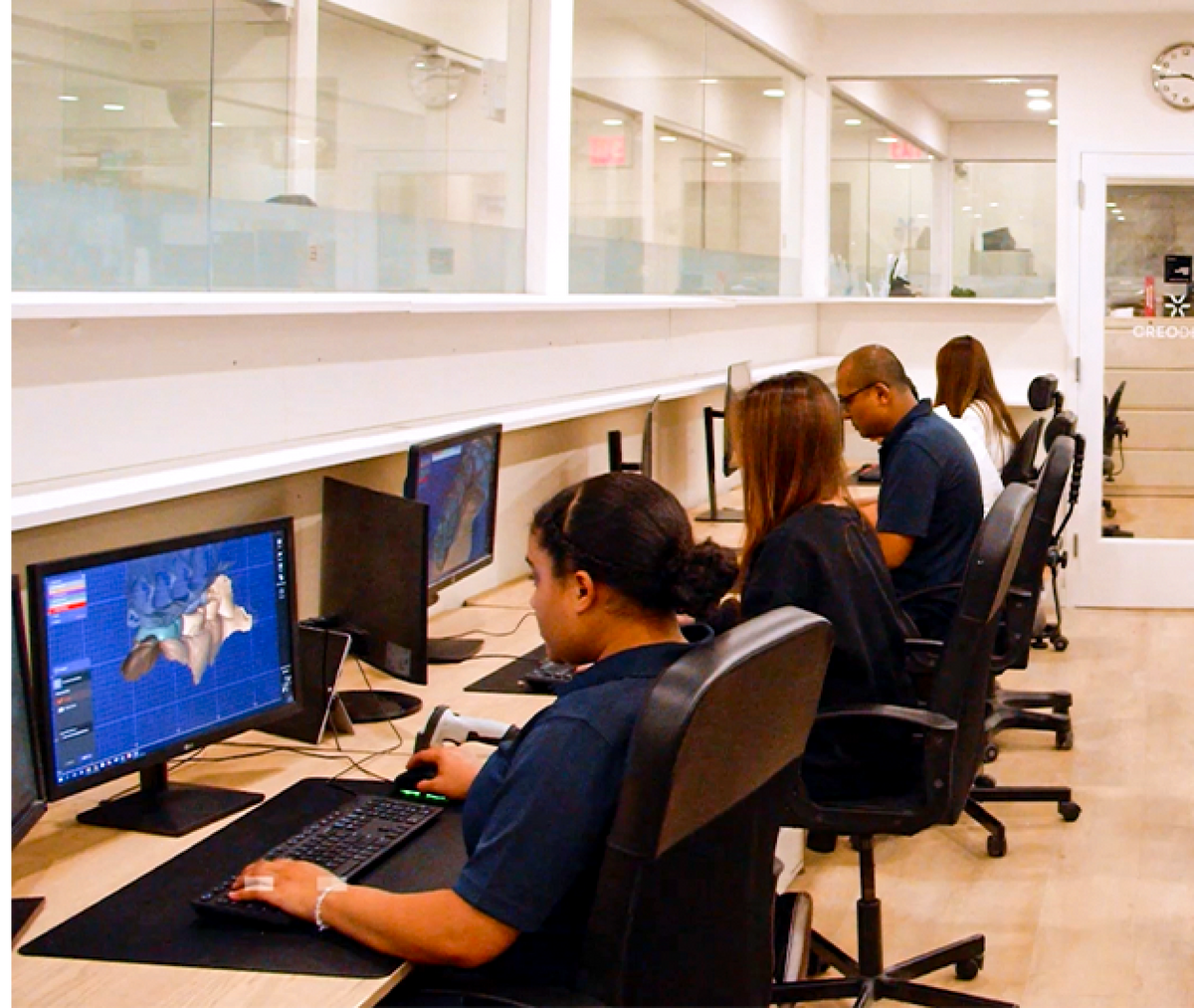 Lab technicians at digital workstations